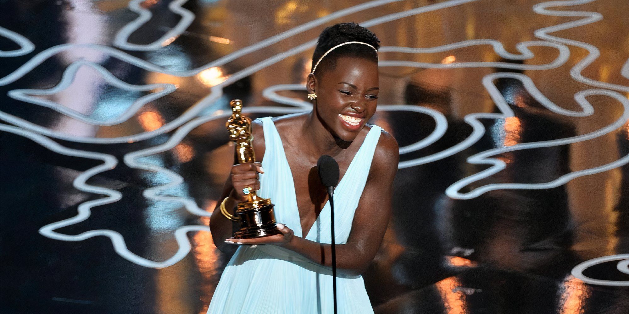 Lupita Nyong&rsquo;o at the 2014 Academy Awards wearing Prada and accepting her Oscar