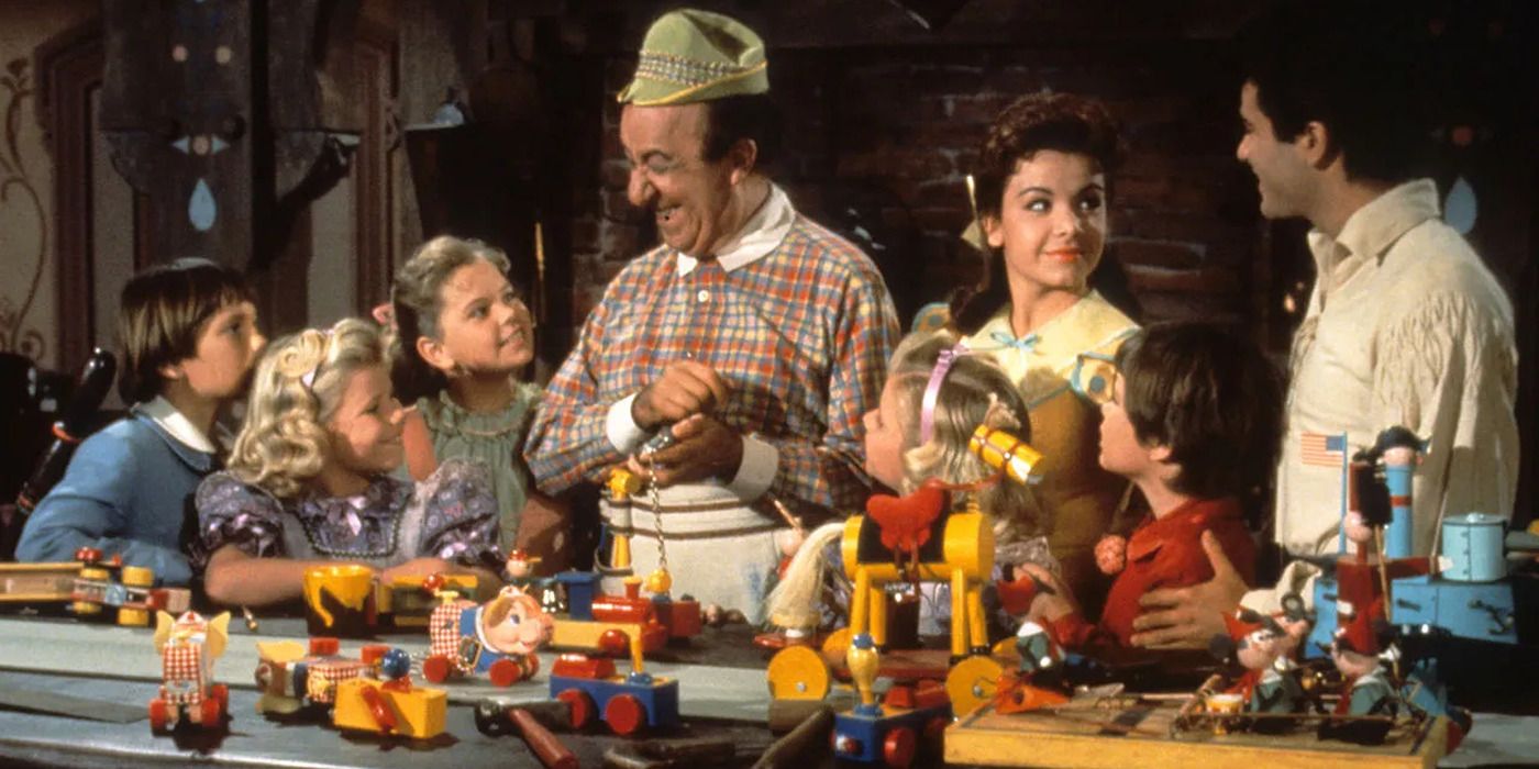Man building toys in front of happy kids and two parents in Babes in Toyland (1961).