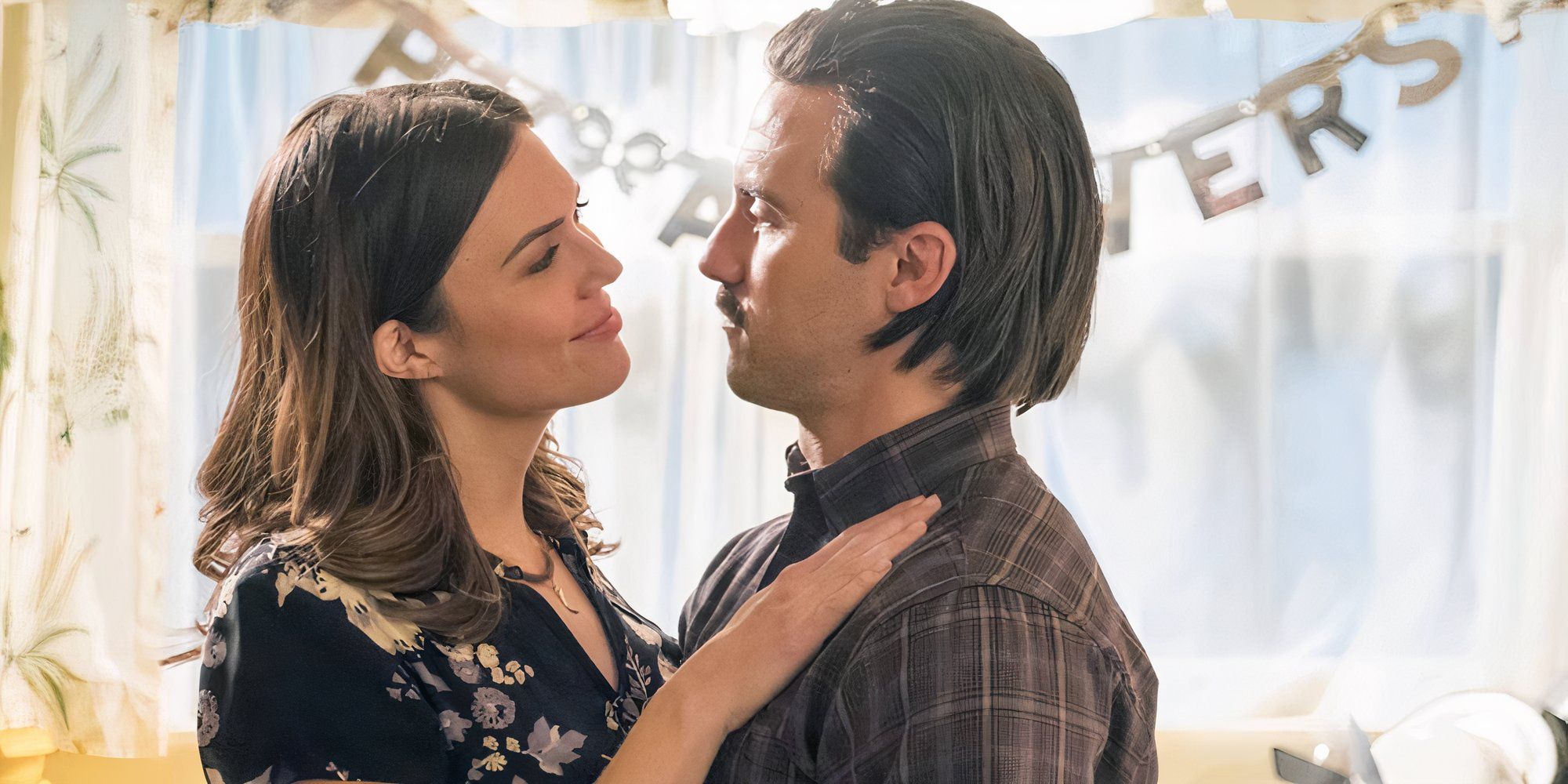 Mandy Moore and Milo Ventimiglia in This is Us looking at each other lovingly.