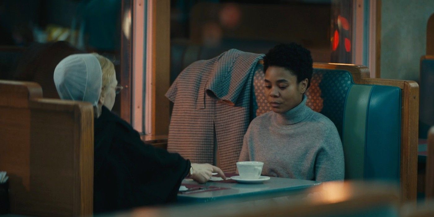 Regina Hall sitting in a diner booth across from a woman in Amish clothing in Master.