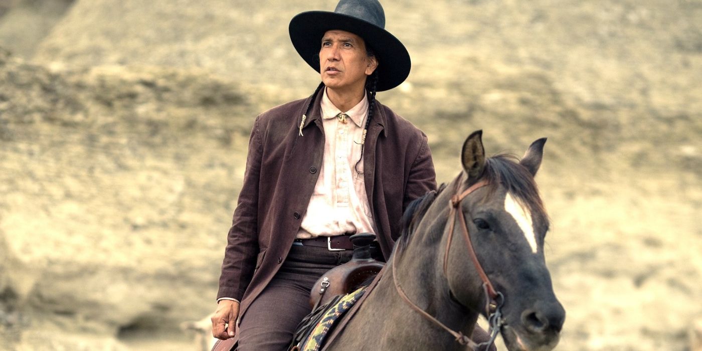 Michael Greyeyes as Hank Plenty Clouds riding a horse and talking to someone off-screen in 1923.