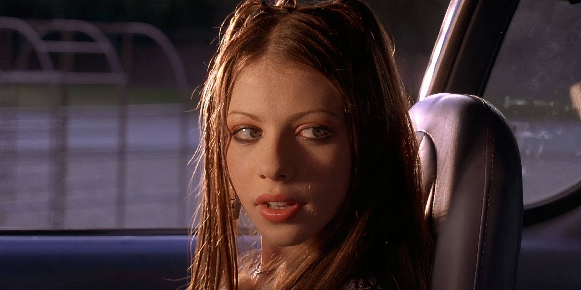 Michelle Trachtenberg as Wendy sitting in a vehicle and looking at someone off-camera in Mysterious Skin.