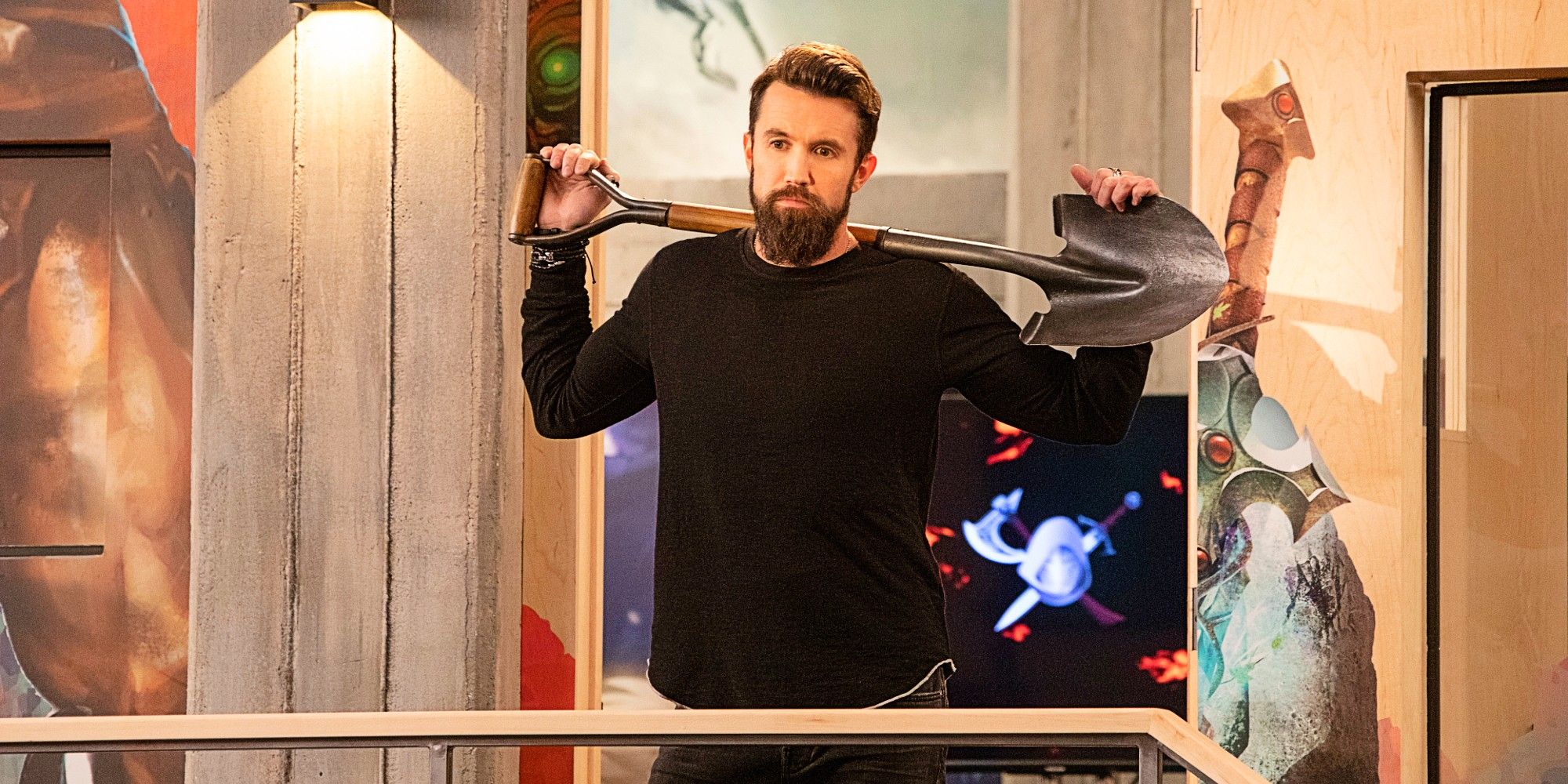 Rob McElhenney as Ian Grimm holding up a shovel in the pilot episode of Mythic Quest