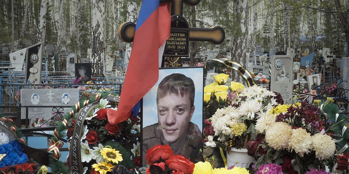 The gravesite of a dead soldier surrounded by flowers in Mr. Nobody Against Putin