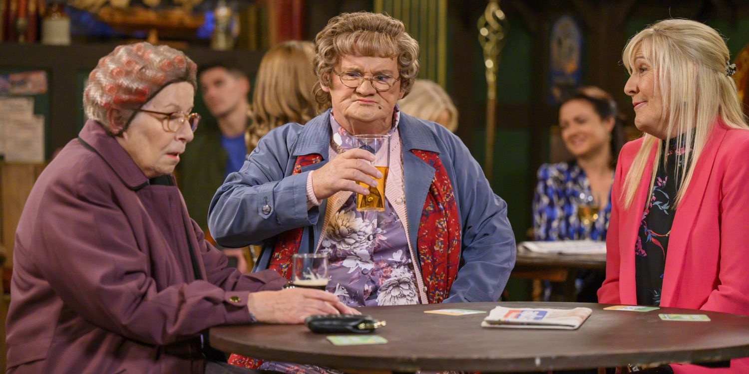 Three ladies at a table in a pub, one with curlers in their hair and another holding a pint in Mrs. Brown&rsquo;s Boys