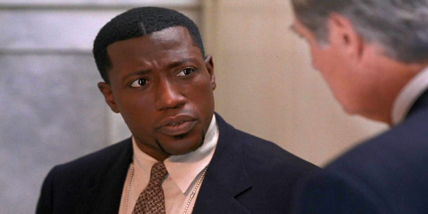 Wesley Snipes looking suspiciously at a man in Murder at 1600.
