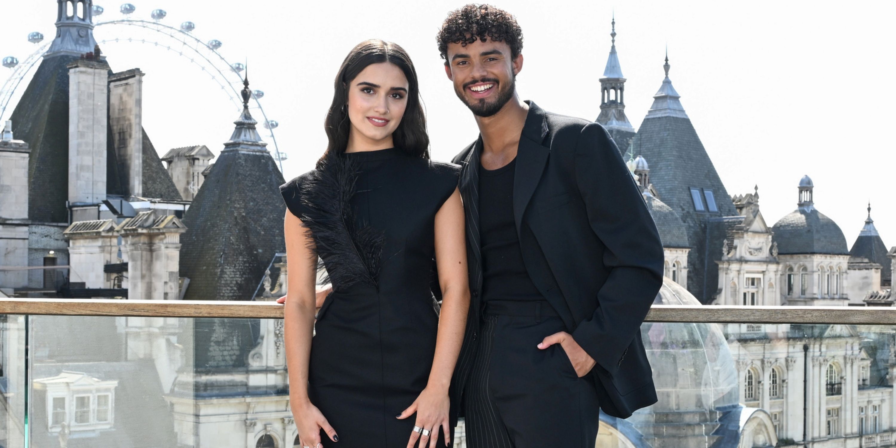 Asha Banks in a black dress and Matthew Broome in a black suit at an outdoor photo call for My Fault: London