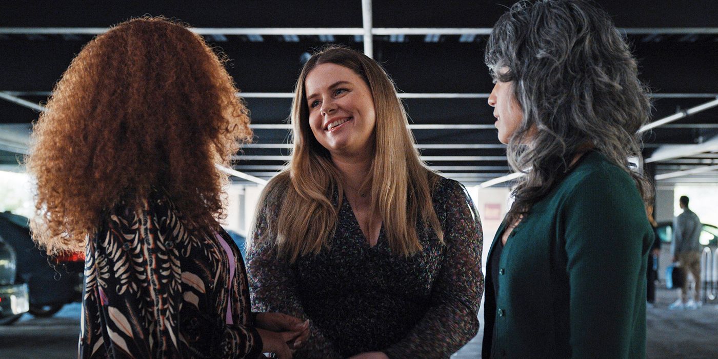 Jessie Ennis smiling at Imani Hakim and Ashyl Burch in a parking garage in Mythic Quest