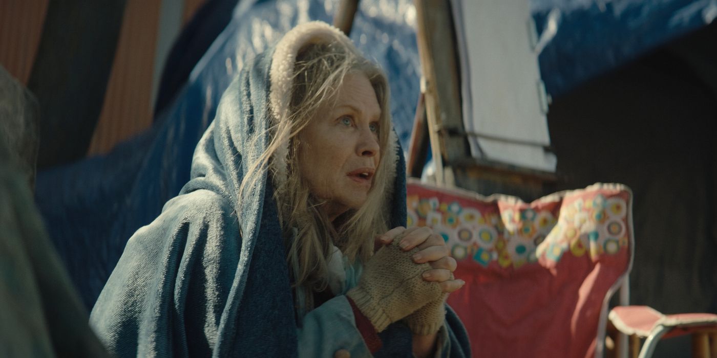 Beverly D&rsquo;Angelo as Dora, sitting wrapped in a blanket and clasping her hands in No Address