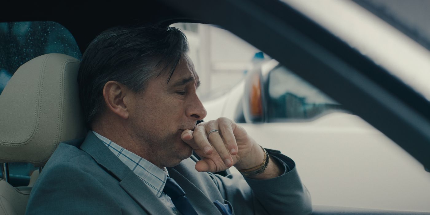 William Baldwin as Robert, sitting in his car and crying with his hand to his mouth in No Address