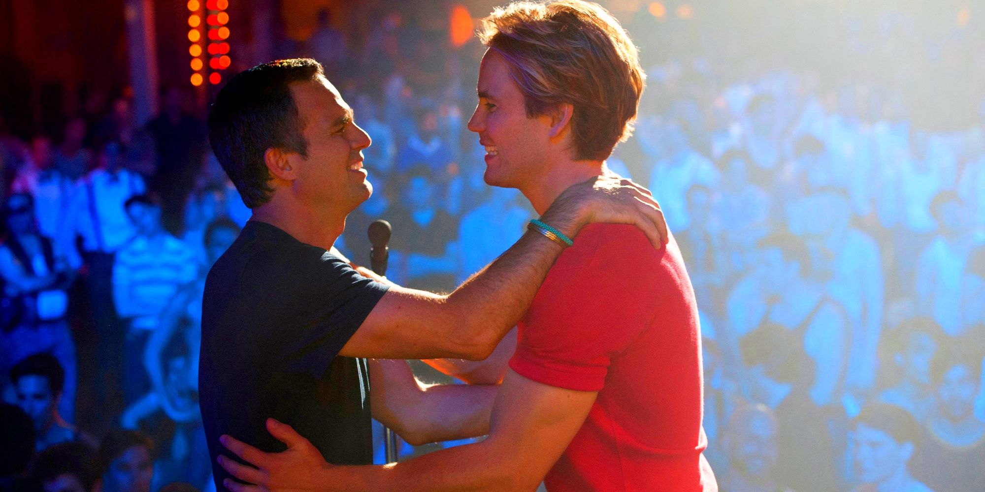 Ned and Felix, played by actors Mark Ruffalo and Matt Bomer, embrace each other on a stage in front of an audience in The Normal Heart.