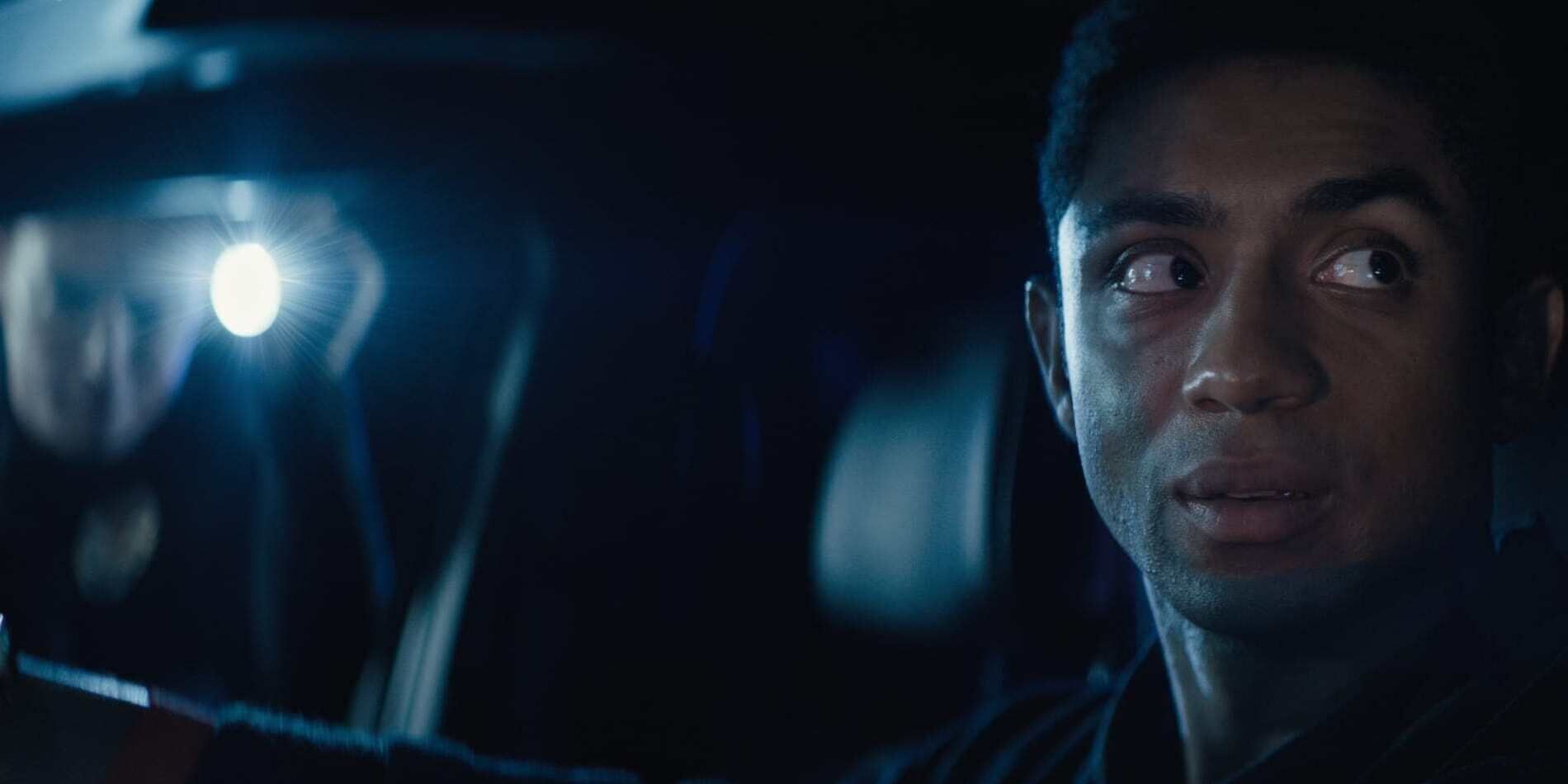 Steven Silver as Tunde Johnson with a look of fear on his face as a flashlight shines into his car in &lsquo;The Obituary of Tunde Johnson&rsquo; (2019)