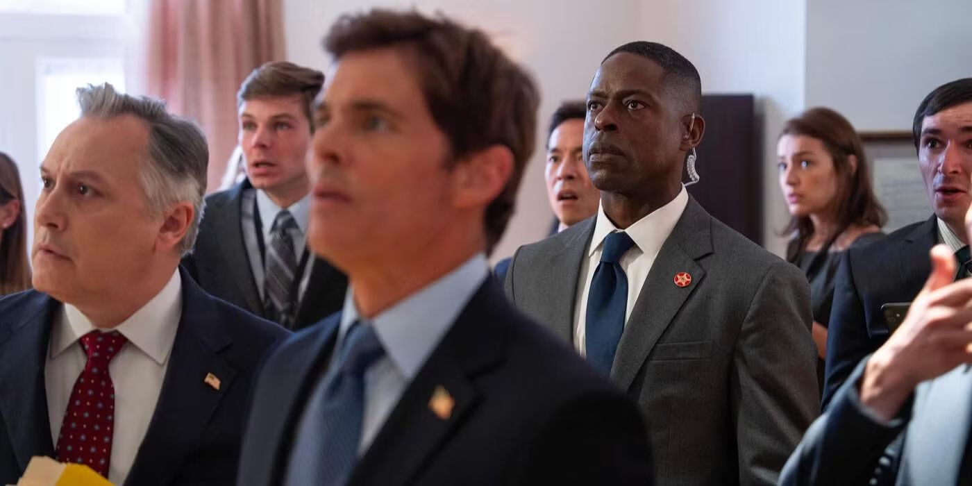 Cal Bradford (James Marsden) and Xavier Collins (Sterling K. Brown) staring up at a TV in Paradise