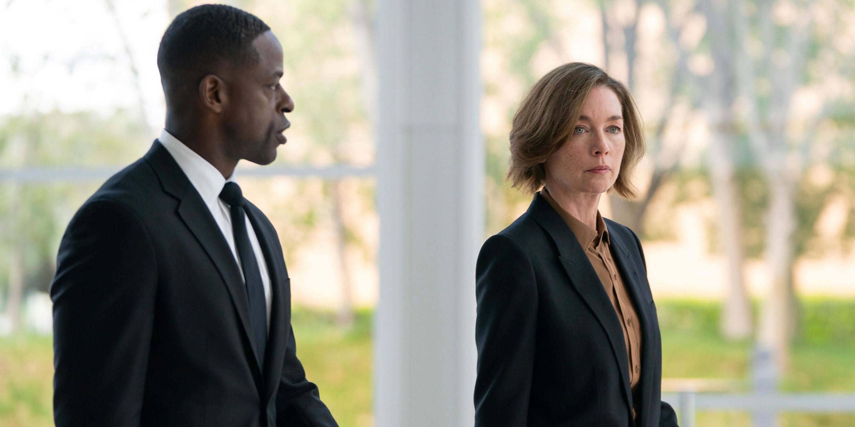 Sterling K. Brown as Xavier Collins walking outside with Julianne Nicholas as Sinatra in Paradise