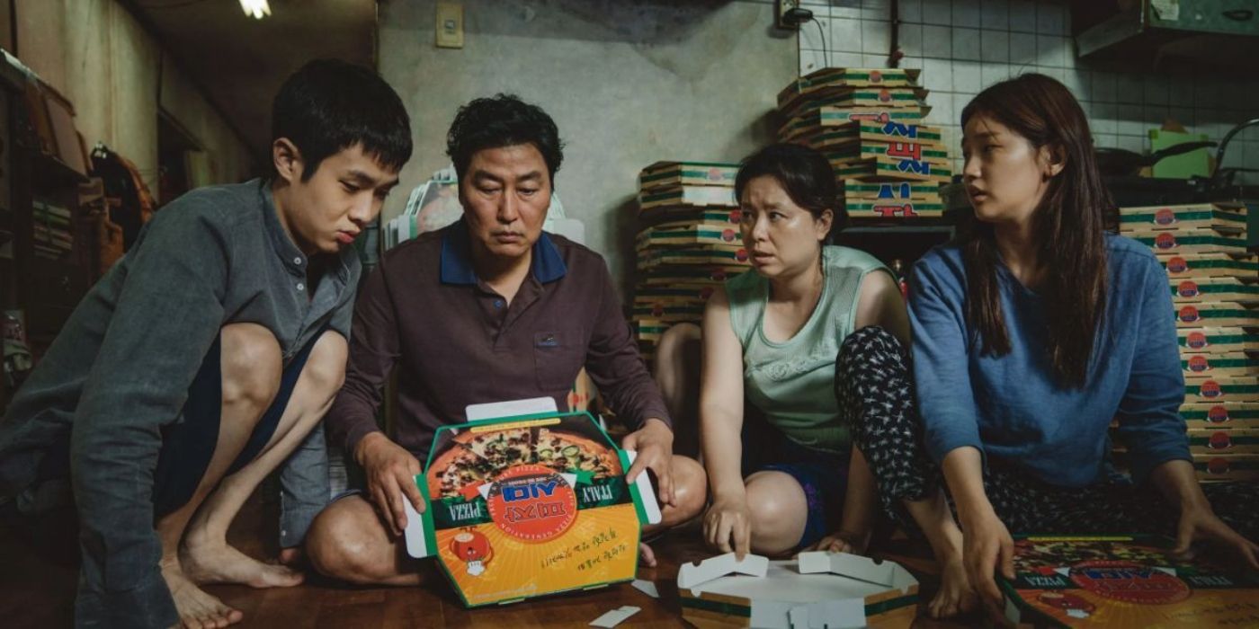 The Kim family assembles pizza boxes in a scene from 'Parasite'