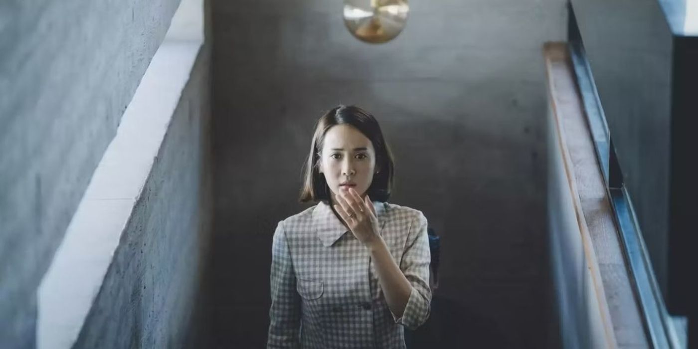 Cho Yeon-jo climbs a staircase in a scene from Parasite