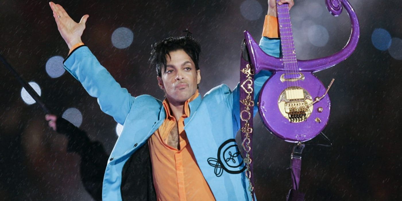 Prince holds up a purple guitar at the 2007 Super Bowl