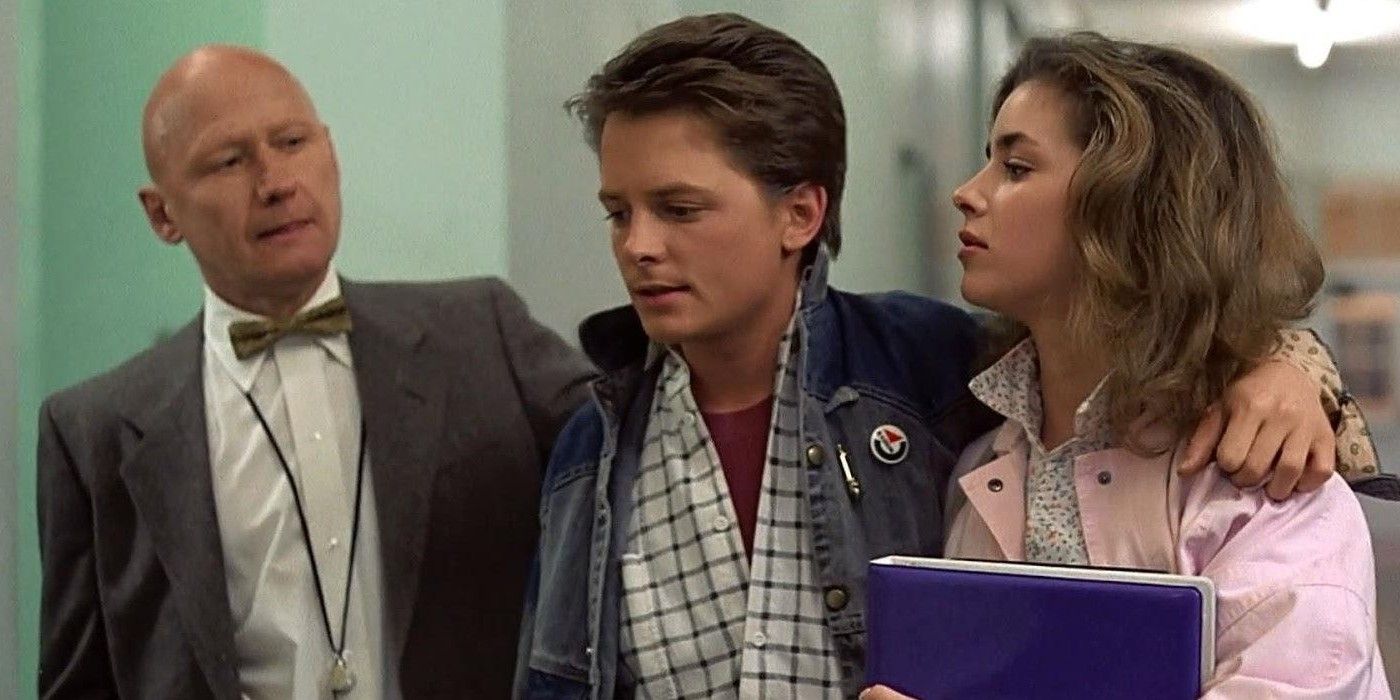 Marty McFly (Michael J. Fox) and Jennifer Parker (Claudia Wells) run into James Tolkan as Principal Strickland in 'Back to the Future'