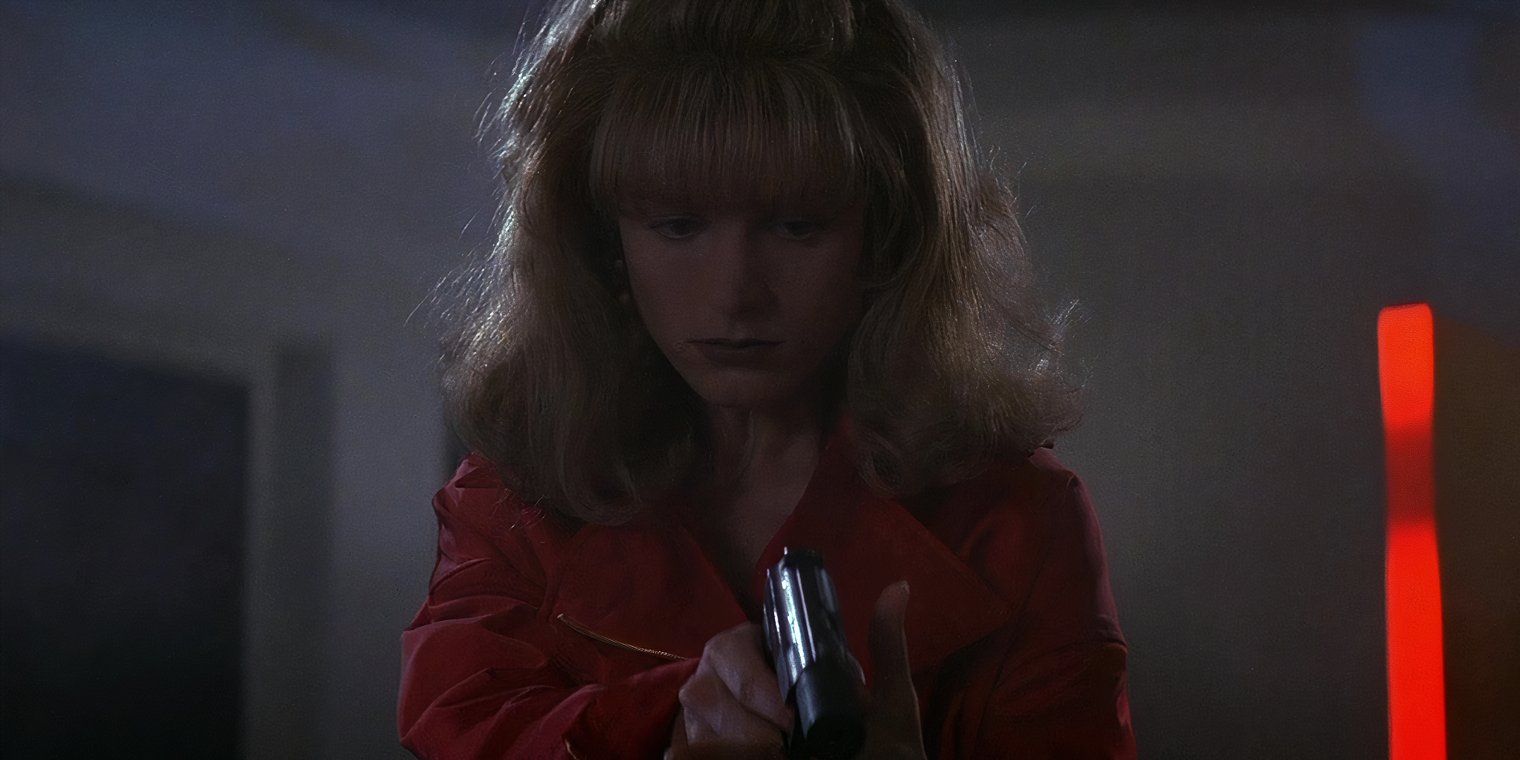 Bridget Fonda aims a gun in Point of No Return.