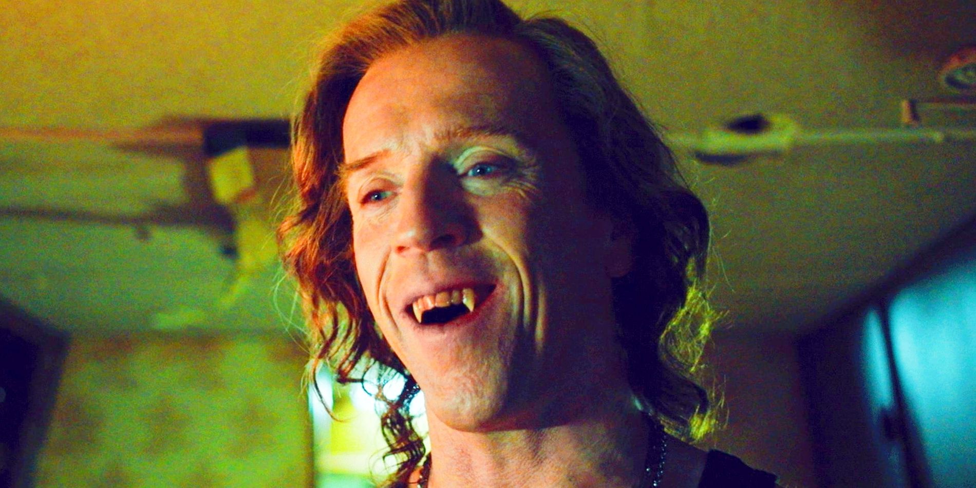 Actor Damien Lewis as Mr. Radley, baring his bloody fans in The Radleys.