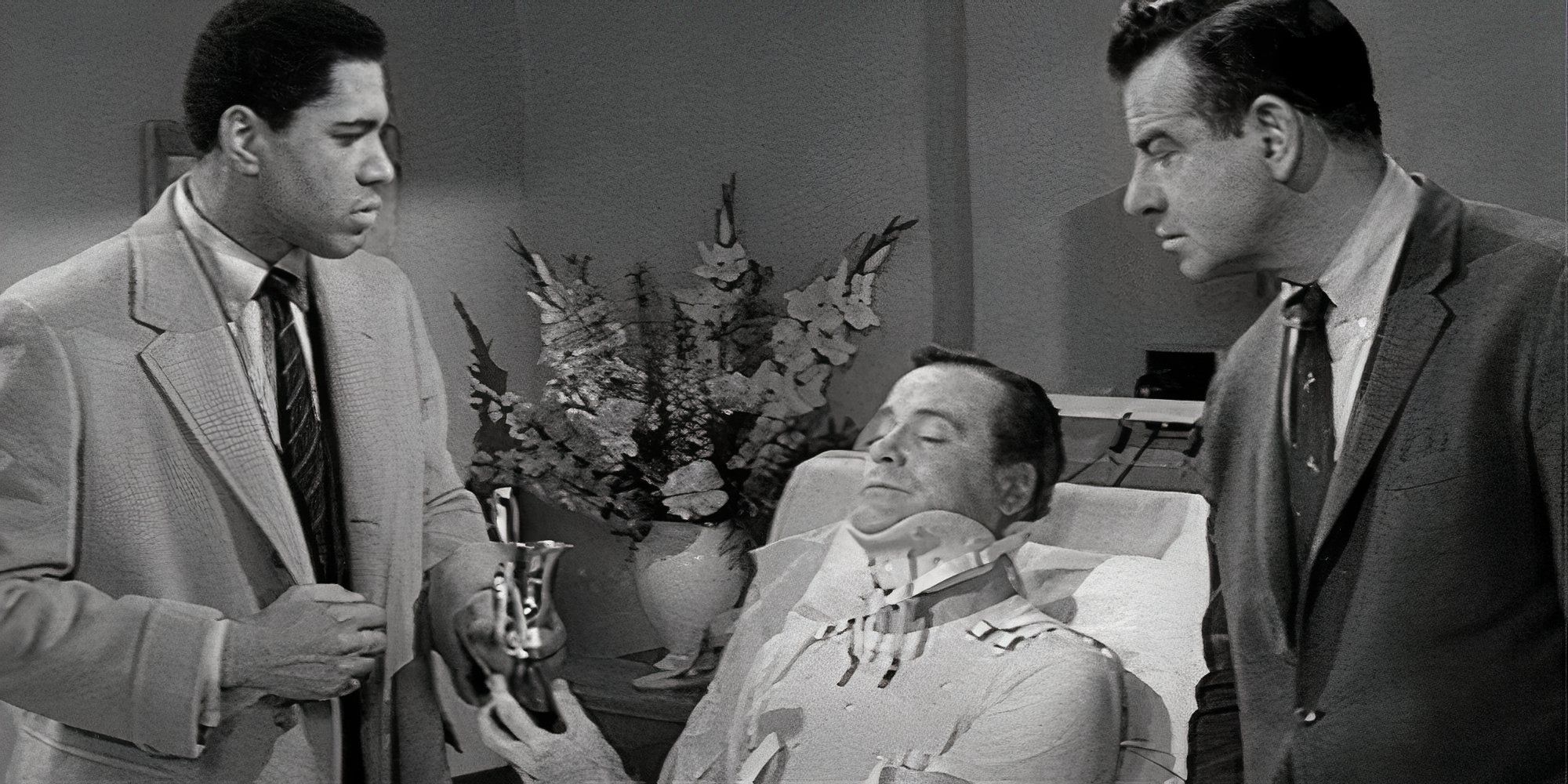 Ron Rich and Walter Matthau standing on opposite sides of a hospital bed with Jack Lemmon laying in it wearing a neck brace in The Fortune Cookie (1966)