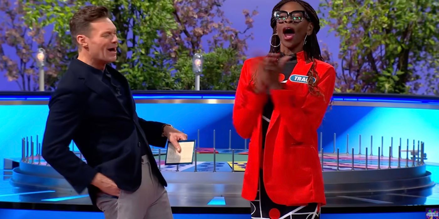 Ryan Seacrest and Traci Demus-Gamble celebrate her Bonus Round win on Wheel of Fortune.