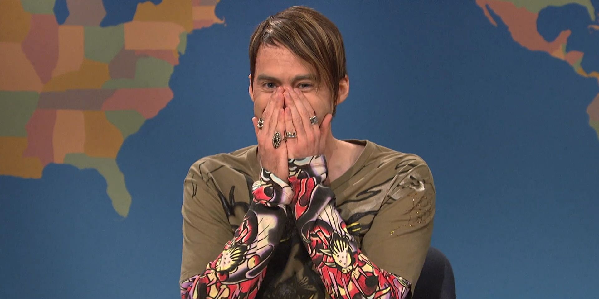 Stefon, played by Bill Hader, laughs with his hands over his mouth in &lsquo;Saturday Night Live&rsquo;.