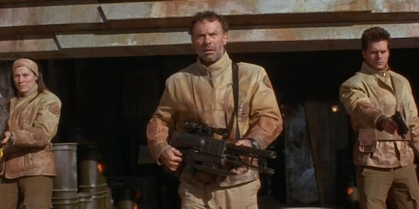 Liliana Komorowska, Ron White, and Jason Cavalier wearing brown military uniforms in Screamers.