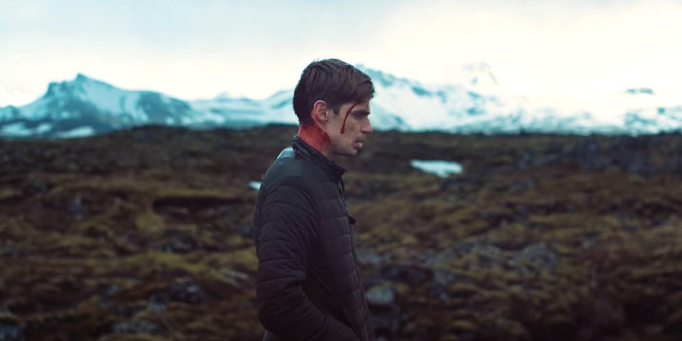 A bloodied Gunnar (Björn Stefánsson) stands against the countryside in the Icelandic queer horror film Rift (2017).