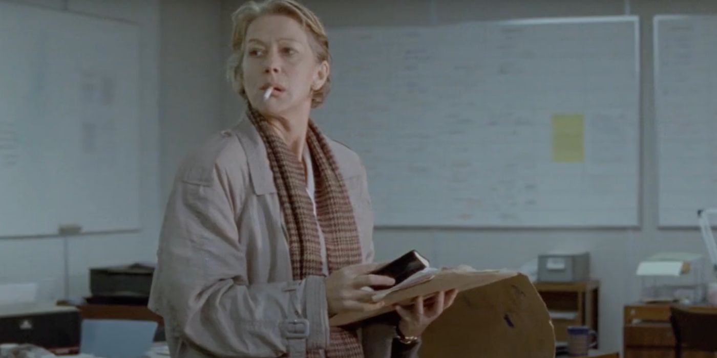 DCI Jane Tennison (Helen Mirren) smokes a cigarette while holding a file in the crime show Prime Suspect.