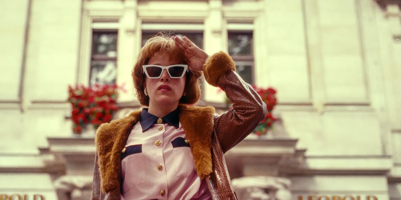 Jella Haase as Kleo wearing a fur coat and sunglasses standing outside in 'Kleo'.