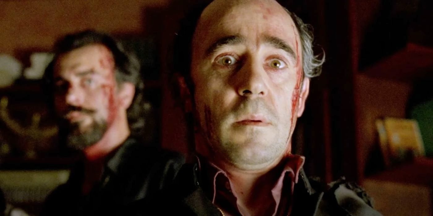 A bloodied Father Ángel (Álex Angulo) sees a sign of the Devil in the horror comedy The Day of the Beast (1995).