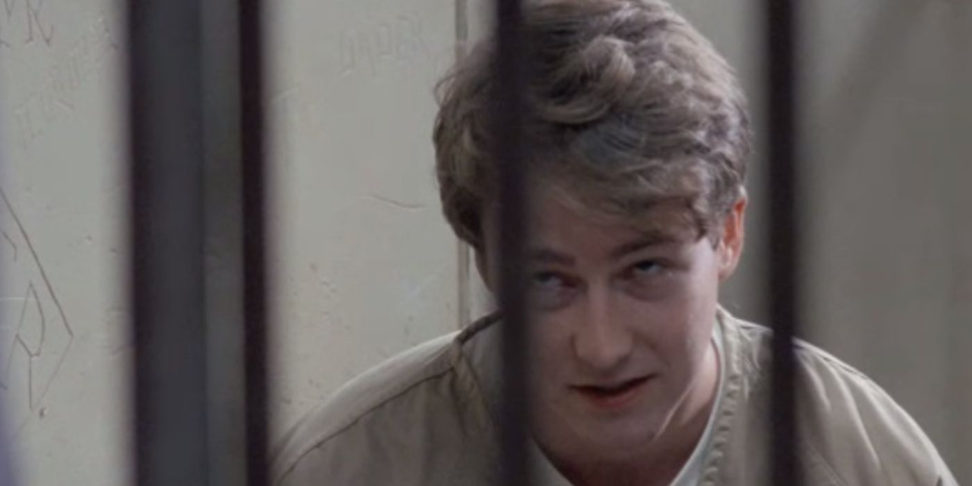 Edward Norton as Aaron wearing a brown prison uniform sitting behind bars in &lsquo;Primal Fear&rsquo;