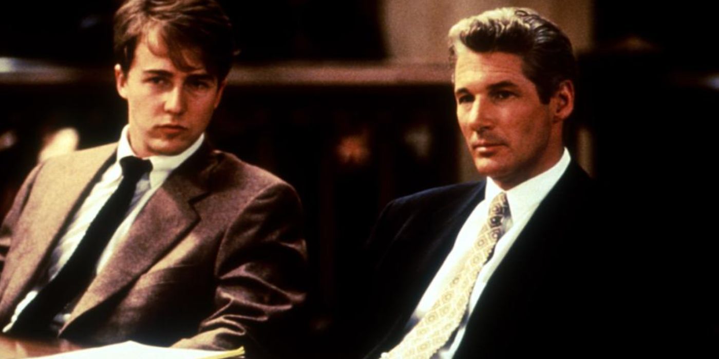 Edward Norton and Richard Gere as Aaron and Martin wearing suits and ties sitting down in a courtroom in 'Primal Fear'