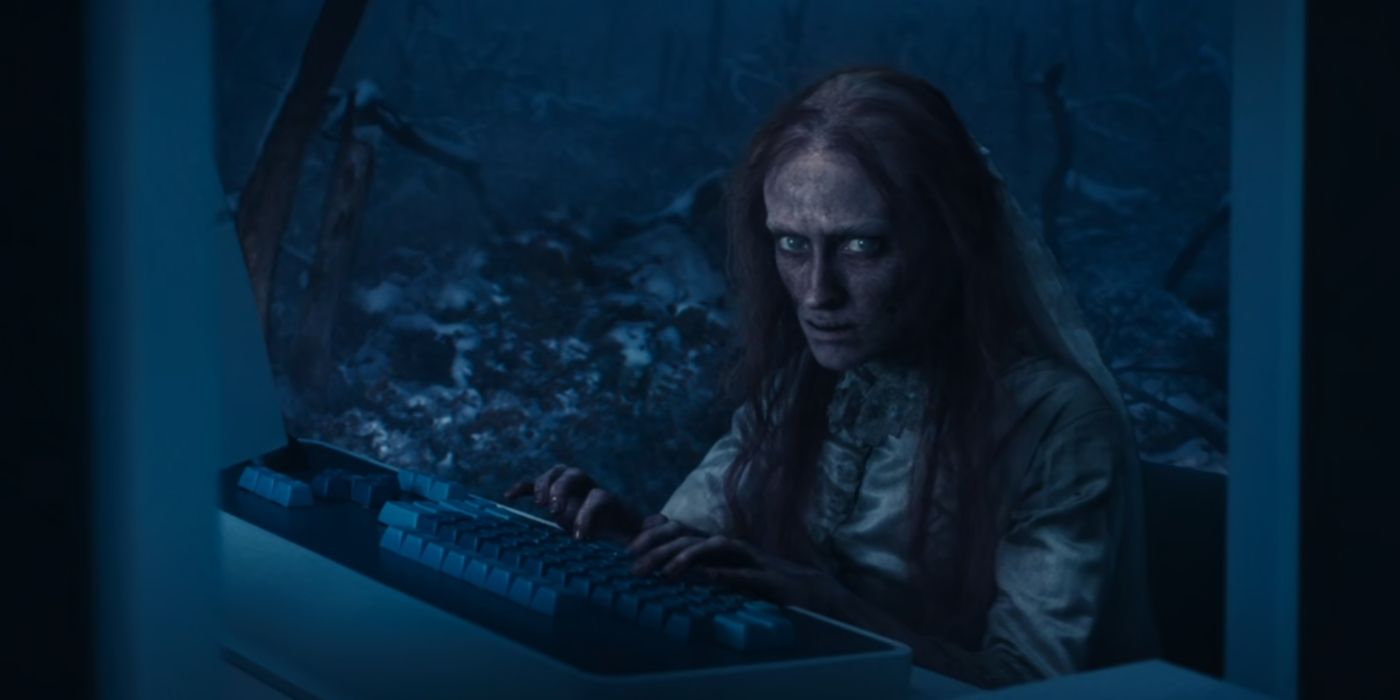 Woe stares at the camera while typing in a scene of Severance Season 2