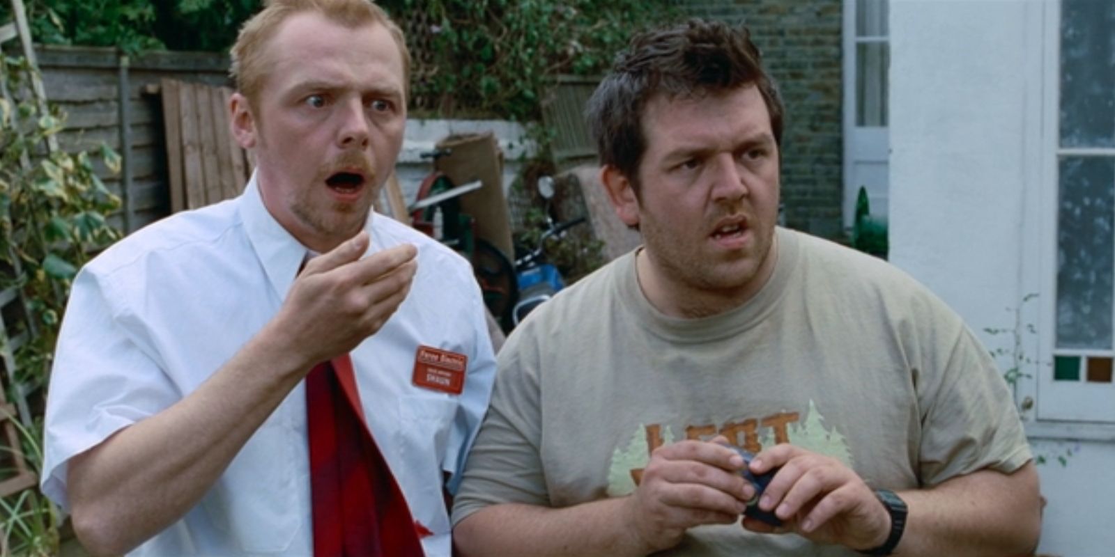 Shaun (Simon Pegg) opens his mouth in disbelief while Ed (Nick Frost) holds a camera in 'Shaun of the Dead'.