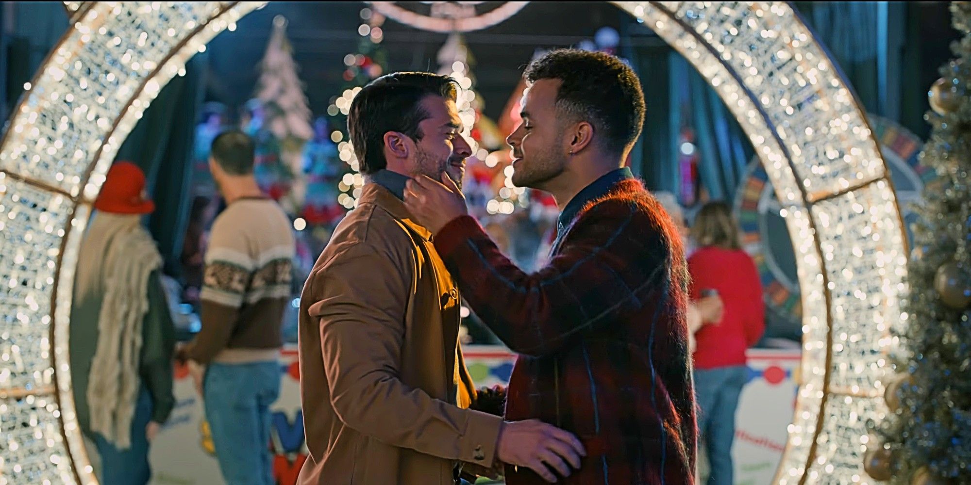 Isaac and Michael kissing during the Christmas festival in Sweet Magnolias Season 4