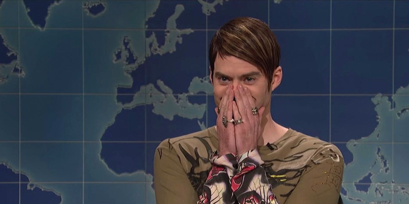 Stefon on Weekend Update on SNL in an Ed Hardy shirt, hands to his mouth smiling.