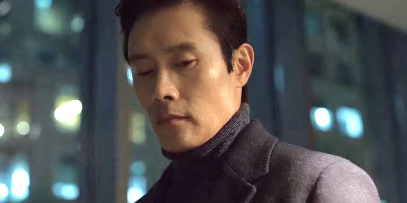 Lee Byung-hun as Hwang In-ho looking down with a city at night in the background in Squid Games.