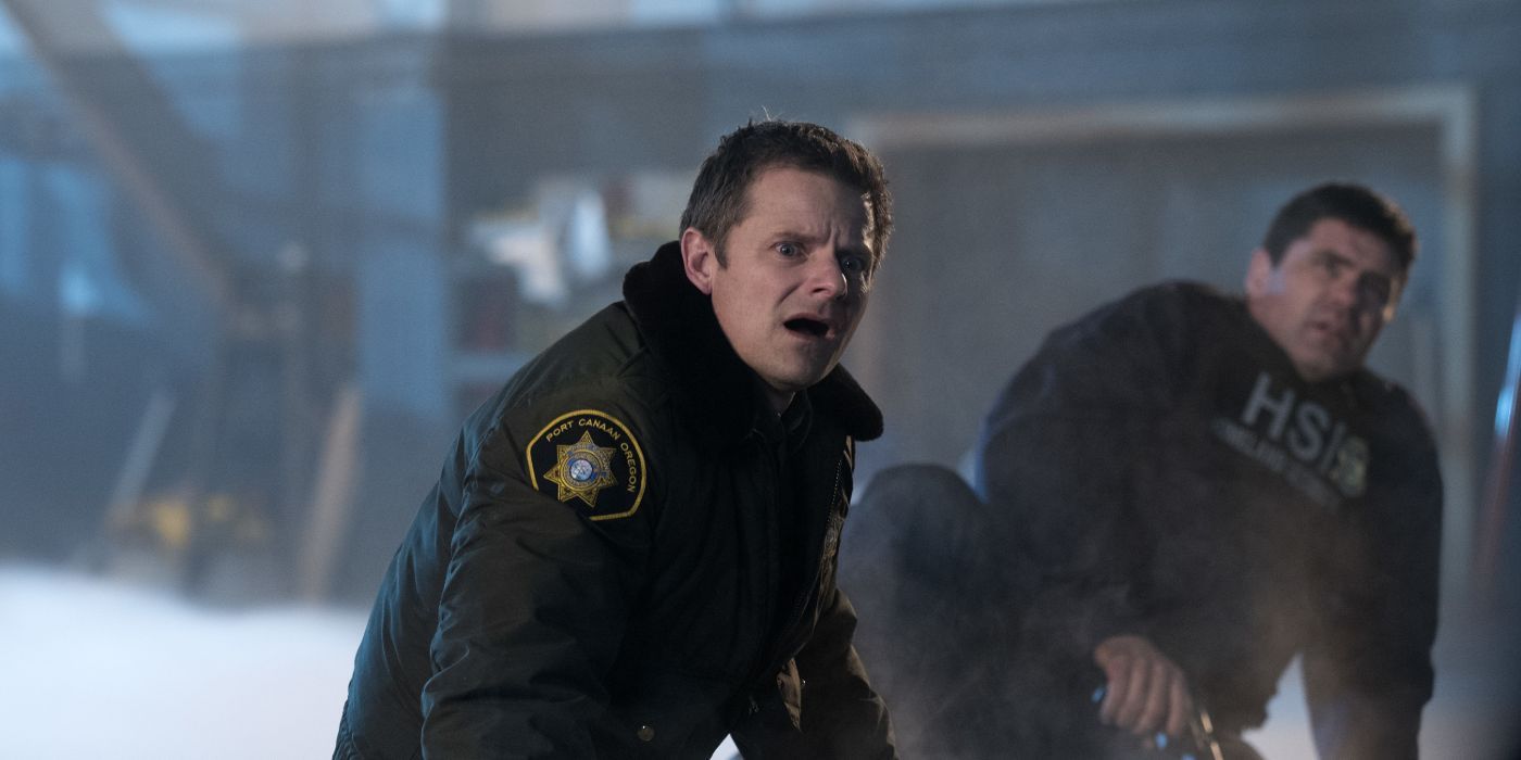 Steve Zahn as Sheriff Jude Ellis on the ground looking shocked with another person behind in The Crossing.