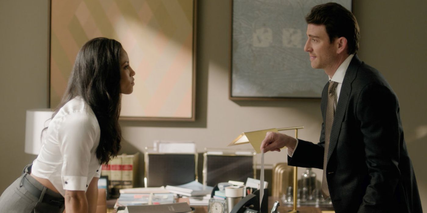 Lex Scott Davis and Bryan Greenberg standing across a desk from each other