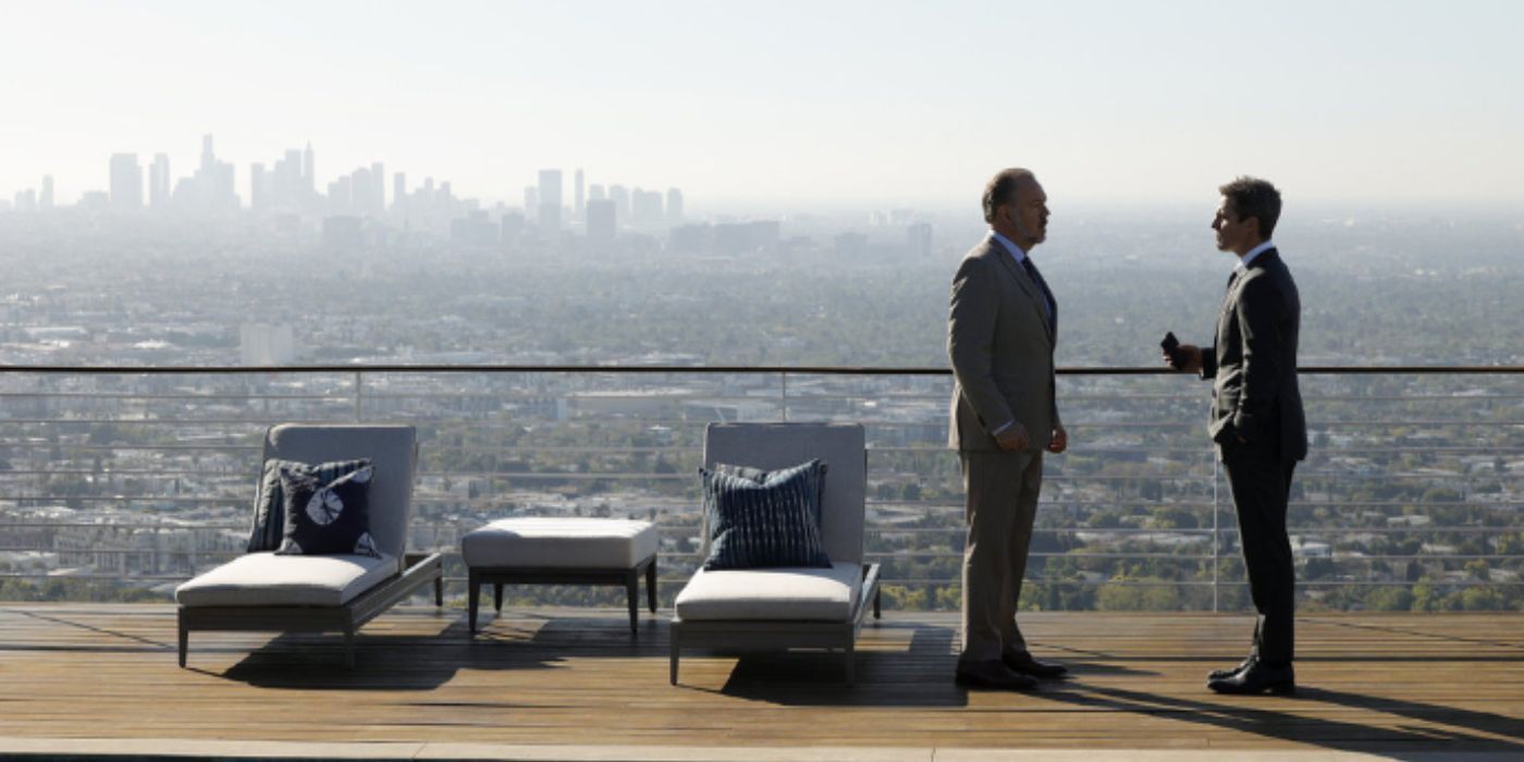 Rob Nagale and Stephen Amell talking on a rooftop in &lsquo;Suits LA&rsquo;.