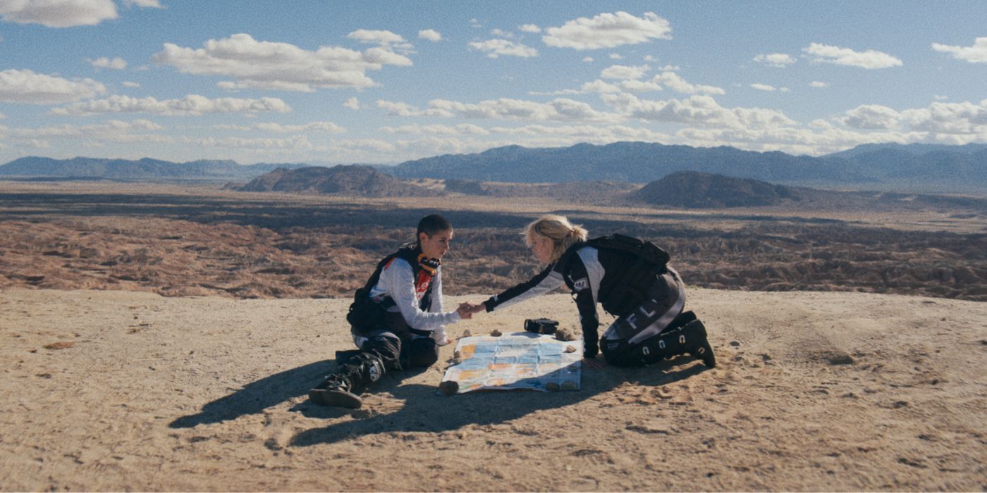 Jenna Kanell and Hannah Alline holding hands in the desert in &lsquo;The Buildout&rsquo;.
