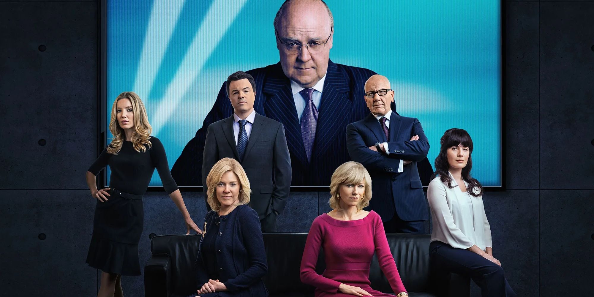 The main cast of The Loudest Voice, with Russell Crowe as Roger Ailes looming on the screen behind them