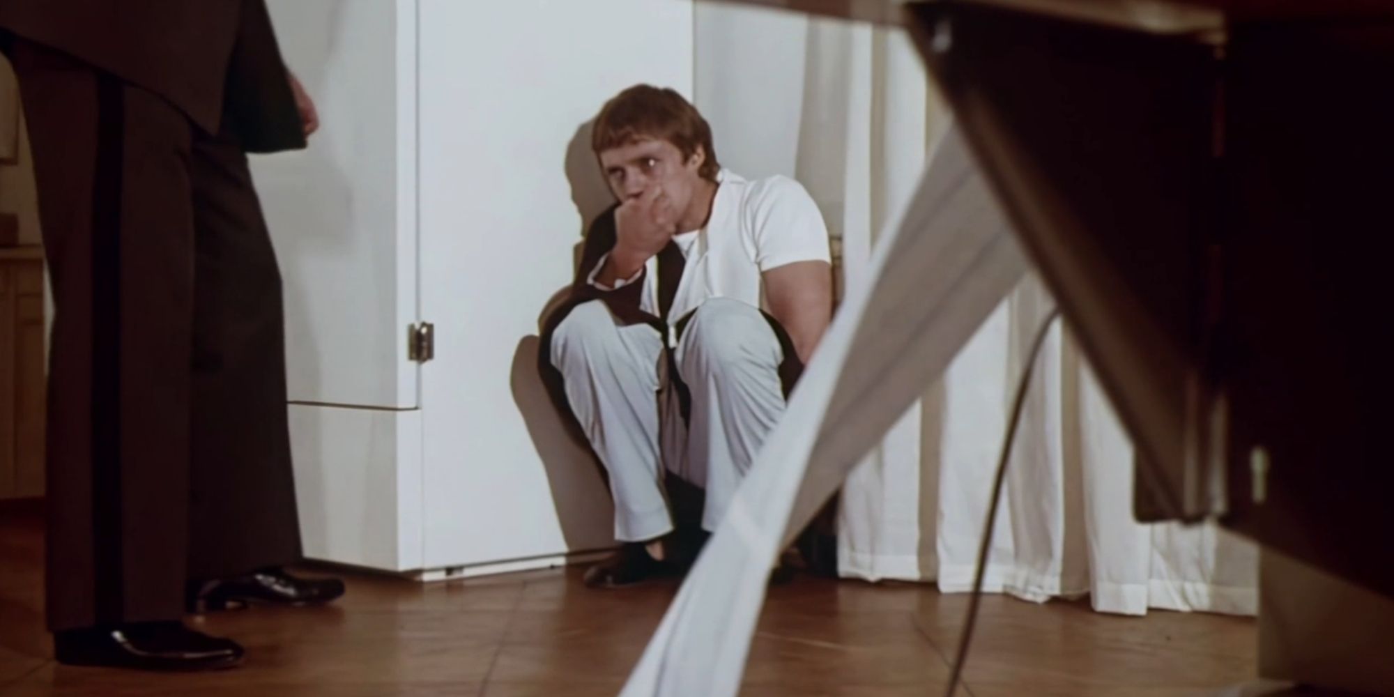 Reese (Christopher Walken) cowers in the corner of a hospital room in The Mind Snatchers