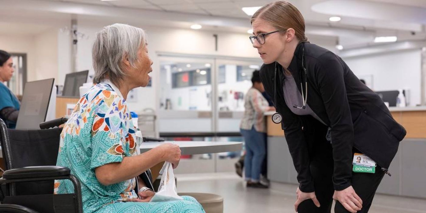 Dr. Mel King (Taylor Dearden) bending down and talking to a patient (Shu Lan Tuan) in The Pitt