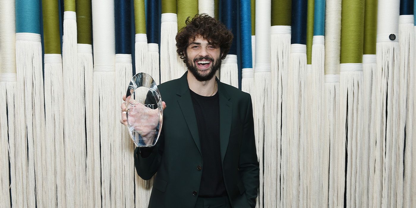 Noah Centineo posing with his Distinguished Performance Award at the 2025 SCAD TVFest for The Recruit
