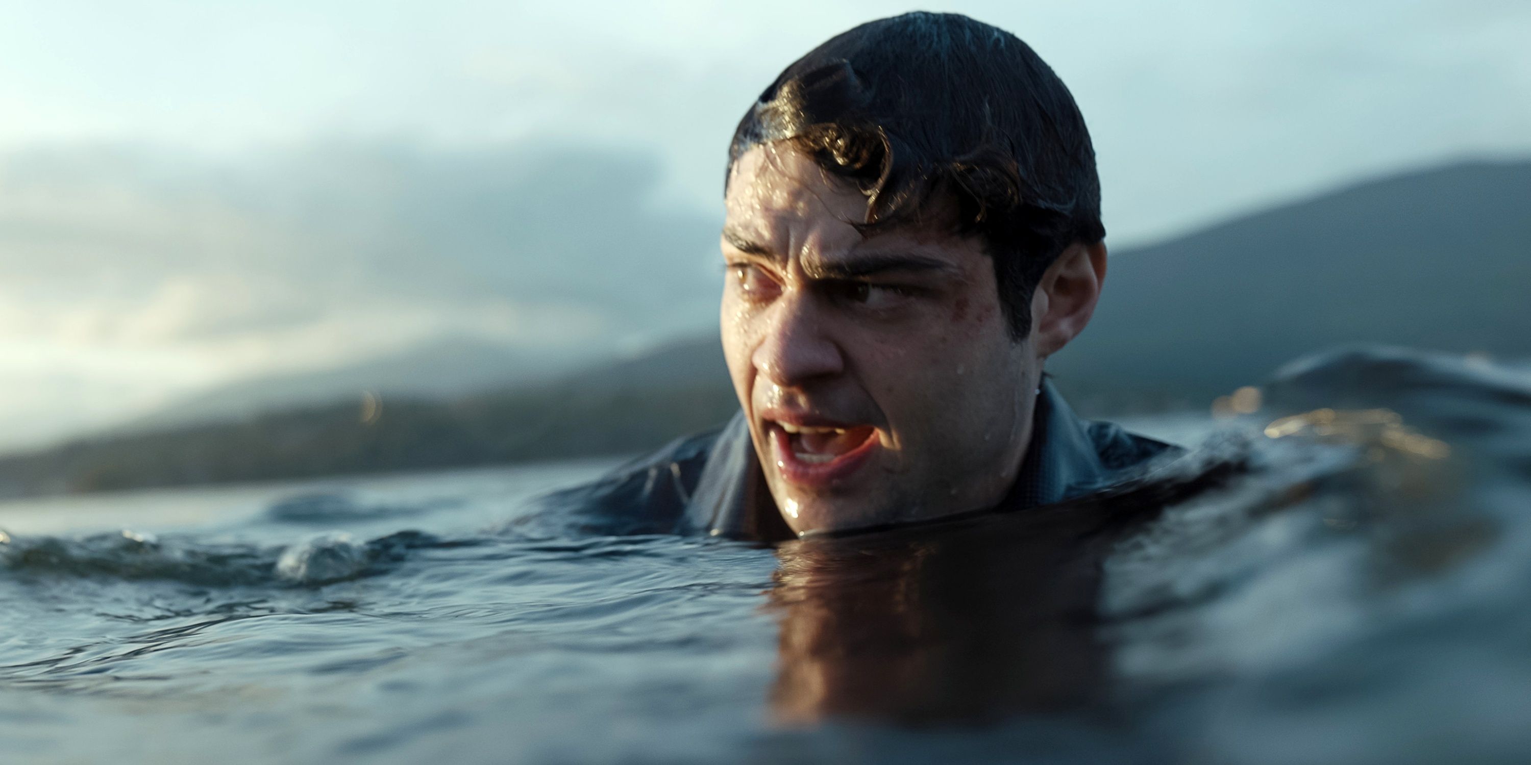 Noah Centineo as Owen Hendricks swimming in freezing water after jumping off a boat in The Recruit