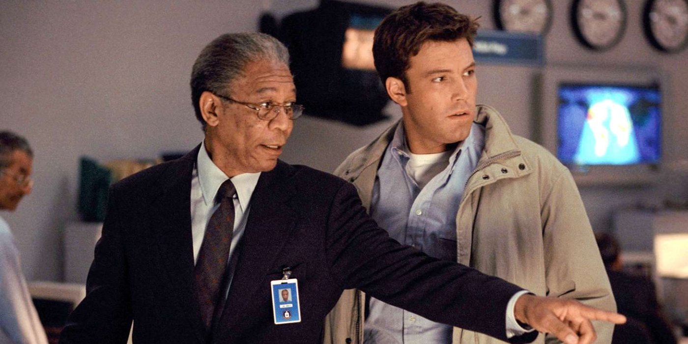 Morgan Freeman points to something as he and Ben Affleck stand in a surveillance room in The Sum of All Fears.