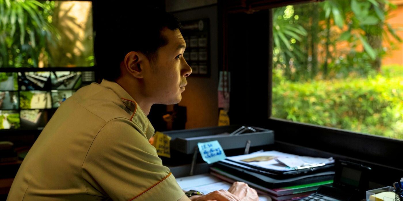 Tayme Thaphimthong as Gaitok in security booth in The White Lotus Season 3, Episode 2.